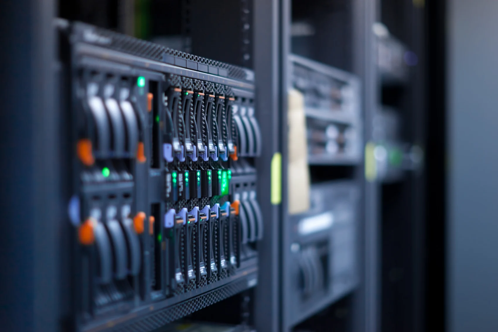 Server racks with illuminated status indicators in a data centre
