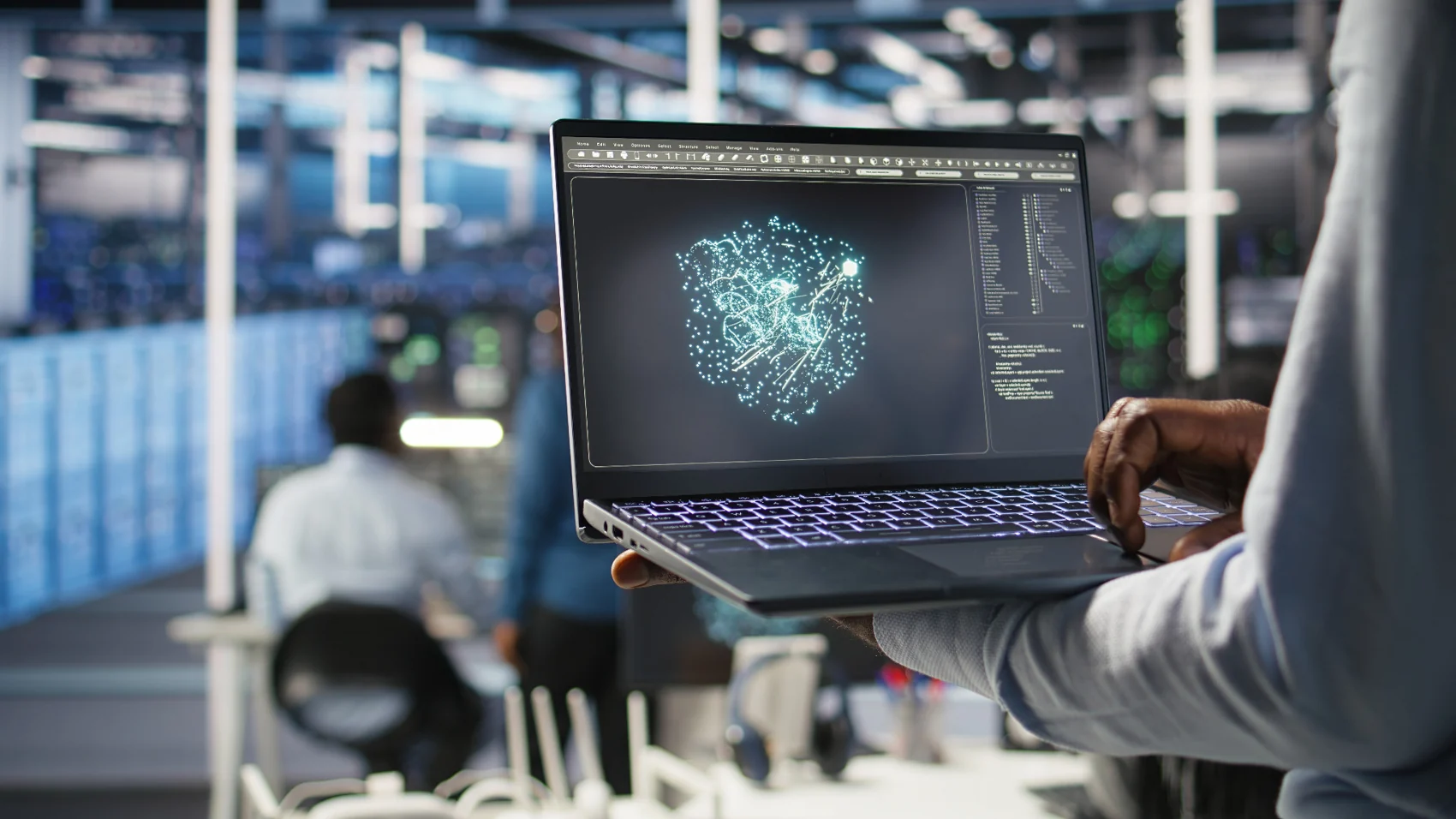Professional holding a laptop displaying data visualisation