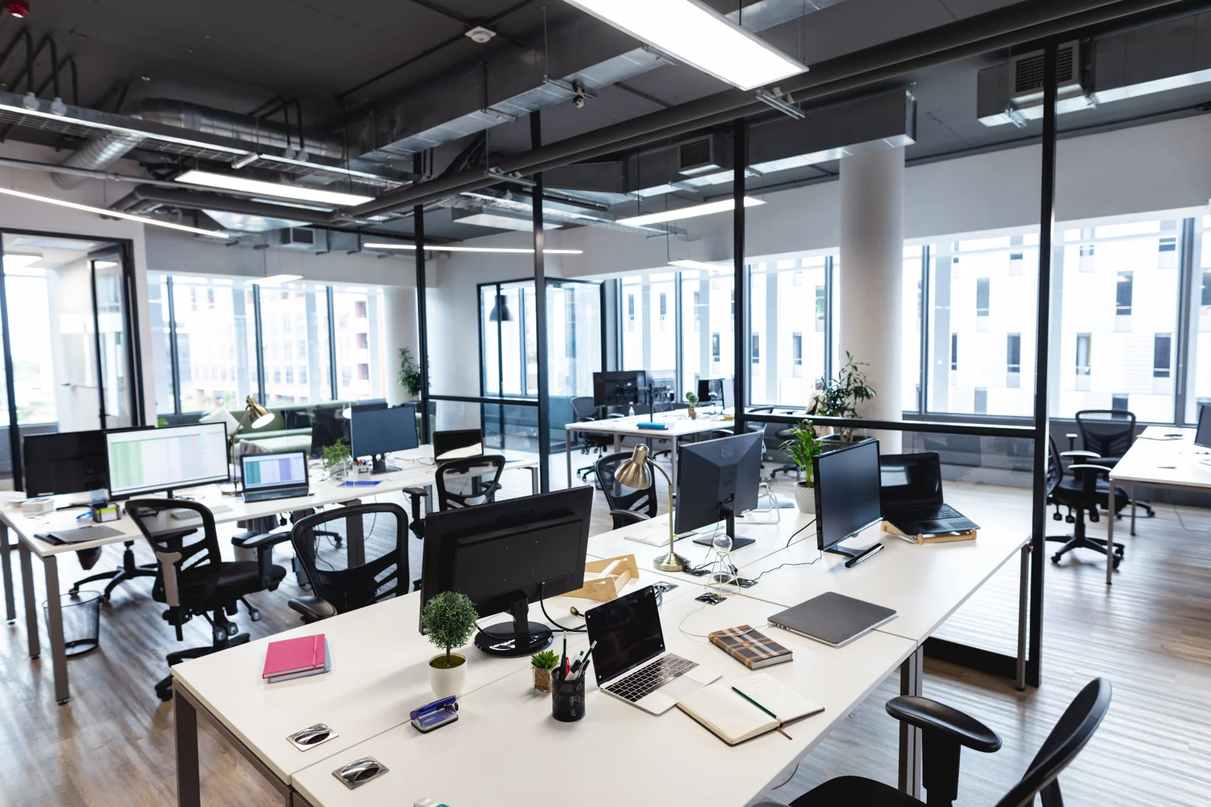 Modern open office with desks, screens and workplace equipment