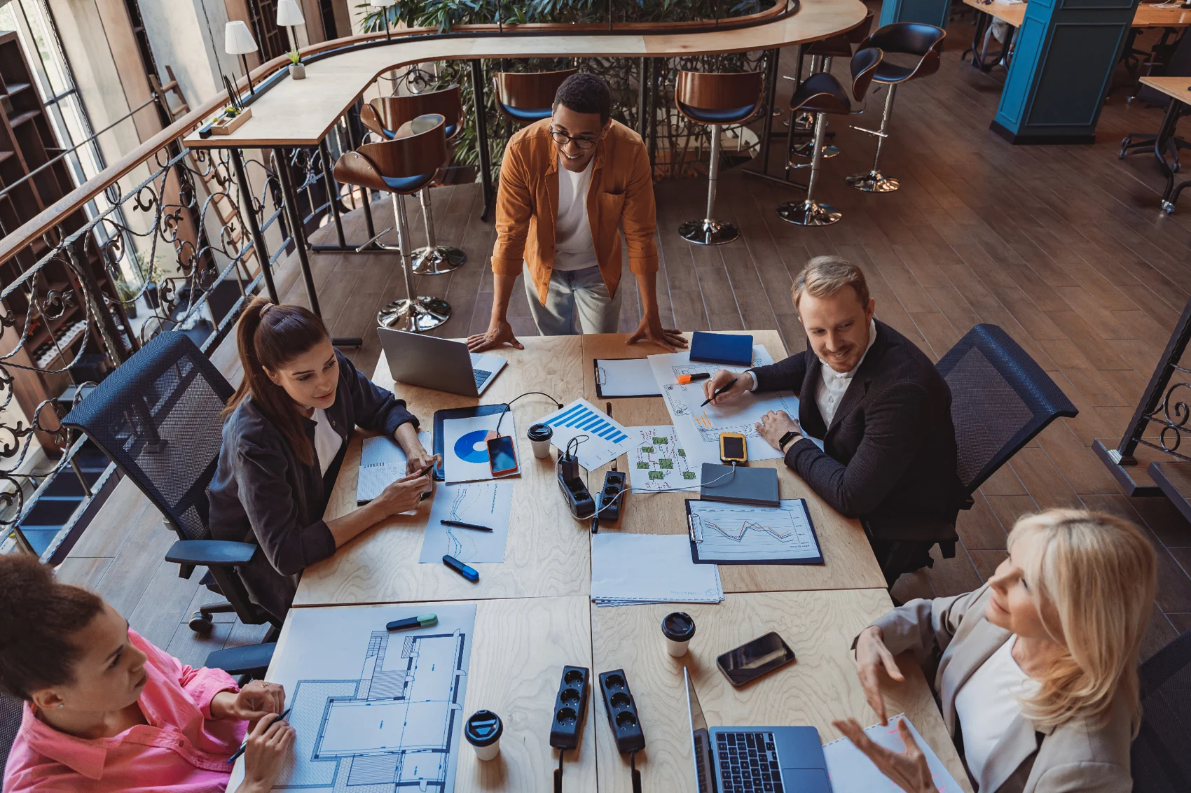 Coworkers planning around a meeting table