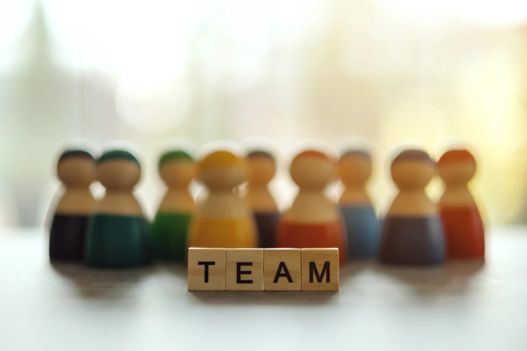 Wooden figures arranged around the word TEAM